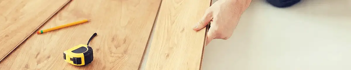 A professional installing wood flooring in Wilmington, NC