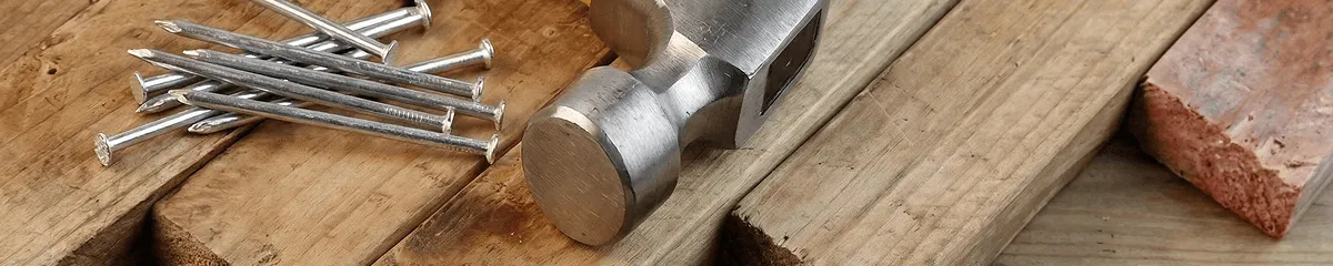 Hammer and nails on hardwood flooring boards in Wilmington, NC