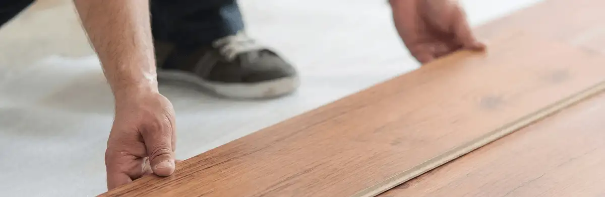 A professional installing laminate flooring in Wilmington, NC